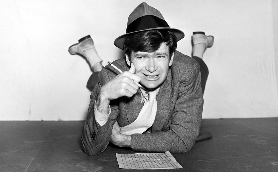 <span><span>Buddy Ebsen looks stumped as he works on a crossword puzzle lying on the floor, 1930s</span><br><span>John Springer Collection/CORBIS/Corbis via Getty Images</span></span>