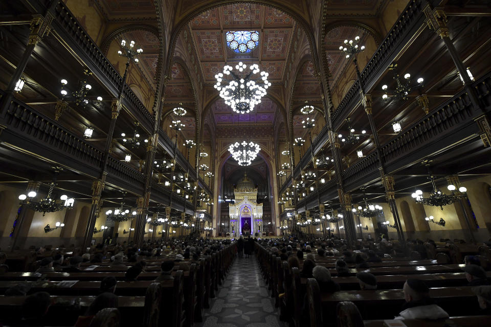 People attend a ceremony that commemorates the 75th anniversary of the liberation of the Budapest Jewish ghetto in Dohany Street Synagogue in Budapest, Hungary, Sunday, Jan. 19, 2020. The ghetto was liberated by the Soviet Red Army during World War II on January 17, 1945. (Tibor Illyes/MTI via AP)