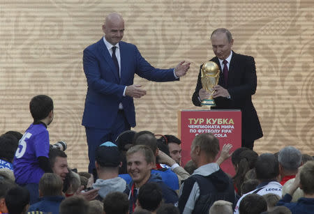 FILE PHOTO: FIFA President Gianni Infantino and Russian President Vladimir Putin attend the FIFA World Cup Trophy Tour kick-off ceremony at the Luzhniki Stadium, which will host matches of the 2018 FIFA World Cup, in Moscow, Russia September 9, 2017. REUTERS/Maxim Shemetov/File Photo
