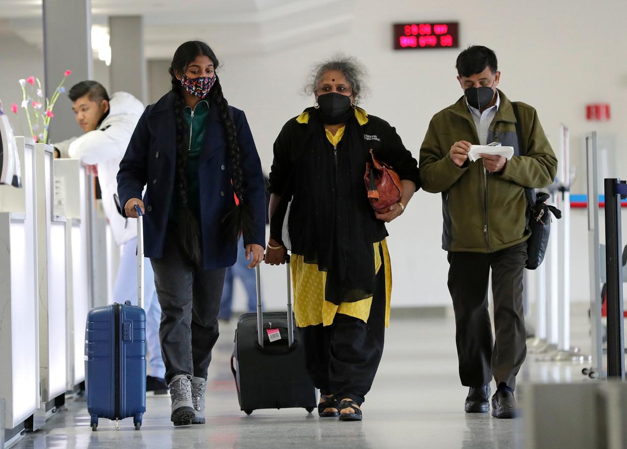 Padmini Sarma, left, is traveling with her parents Nandini Sarma and Sinjaraju Sarma, right, to visit her brother in Detroit. They are seen here making their way to their departure gate at the Appleton International Airport Tuesday, April 19, 2022, in Greenville, Wis. Dan Powers/USA TODAY NETWORK-Wisconsin