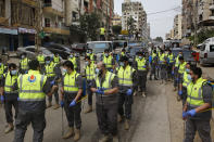 In this Friday, March 27, 2020 photo, members of the Islamic Health Society, an arm of the Iran-backed militant Hezbollah group prepare to spray disinfectant as a precaution against the coronavirus, in a southern suburb of Beirut, Lebanon. Hezbollah has mobilized the organizational might it once deployed to fight Israel or in Syria's civil war to battle the spread of the novel coronavirus. It aims to send a clear message to its Shiite supporters that it is a force to rely on in times of crisis -- particularly after it suffered a series of blows to its prestige. Opponents angrily accuse Hezbollah of helping bring the outbreak to Lebanon, saying it delayed a halt of flights from Iran for weeks after a woman who had just arrived from Iran emerged as Lebanon's first confirmed coronavirus case. (AP Photo/Bilal Hussein)