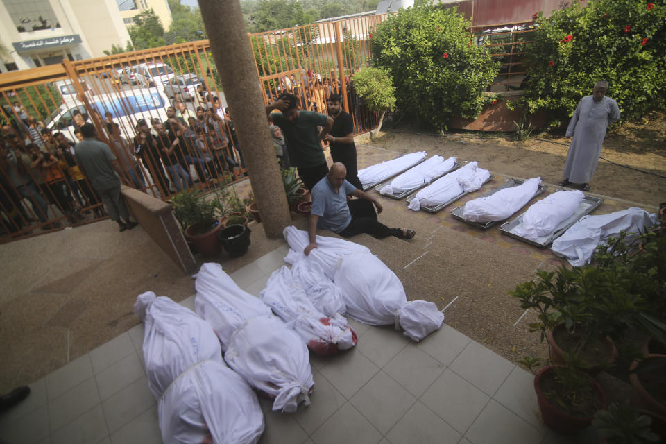 Palestinians gather around the bodies of people killed in Israeli airstrikes during their funeral in Khan Younis, Gaza Strip, Wednesday, Oct. 11, 2023. (AP Photo/Hatem Ali)