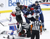 Winnipeg Jets' Mark Scheifele (55) fights with Montreal Canadiens' Phillip Danault (24) during the third period of Game 1 of an NHL hockey Stanley Cup second-round playoff series Wednesday, June 2, 2021, in Winnipeg, Manitoba. (John Woods/The Canadian Press via AP)