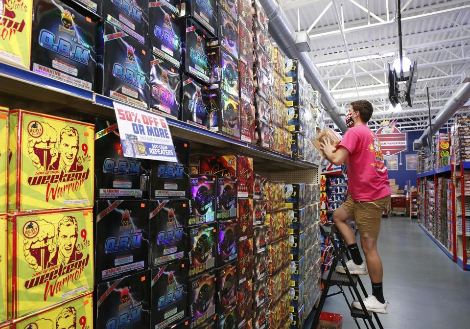 In this file photo, Sky King Fireworks employees work to stock shelves at the store in Daytona Beach. Law enforcement and fire officials urge residents to be extremely careful handling personal fireworks over the July 4th holiday.