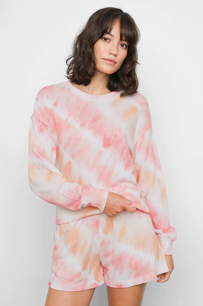 model wearing pink and orange tie dye long sleeve and shorts