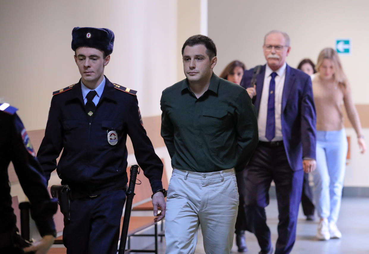 U.S. ex-Marine Trevor Reed, who was detained in 2019 and accused of assaulting police officers, is escorted before a court hearing in Moscow, Russia March 11, 2020. (Tatyana Makeyeva/Reuters)