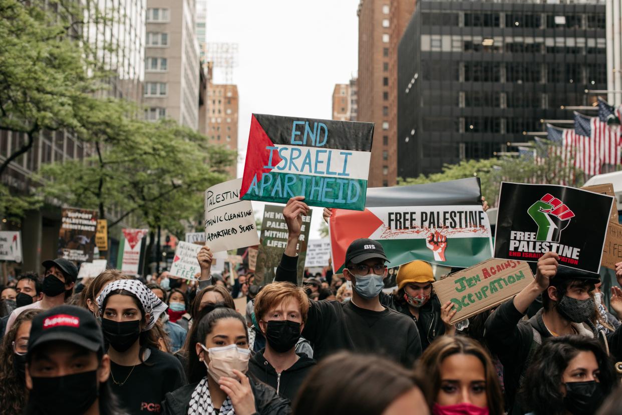 Protesters demanding an end to Israeli aggression against Palestine march in the street in Midtown Manhattan on May 11, 2021, in New York City.