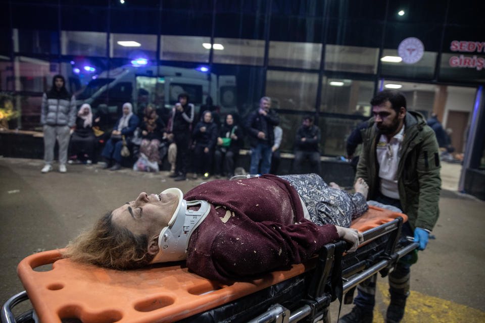 An earthquake survivor is brought to a hospital in Iskenderun, Turkey