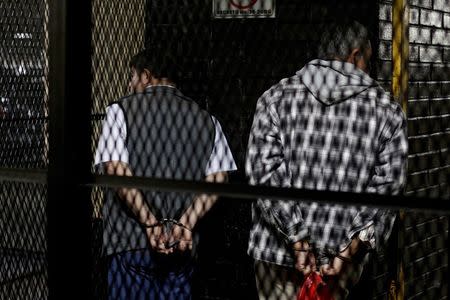 Former Guatemalan Army Colonel Esteelmer Reyes Giron (L) and ex-military commissioner Heriberto Valdez stand handcuffed in a cage after the verdict was given in the Sepur Zarco case in Guatemala City, Guatemala, February 26, 2016. A judge sentenced Giron to 120 years and ex-military commissioner Valdez to 240 years in prison for committing crimes against humanity, as well as sexual violence and slavery against fifteen indigenous women of the Mayan ethnic Q'eqchi group, between 1982 to 1986 at the military base of Sepur Zarco, during Guatemala's bloody 36-year civil war, local media reported. REUTERS/Josue Decavele TPX IMAGES OF THE DAY - RTS87MF