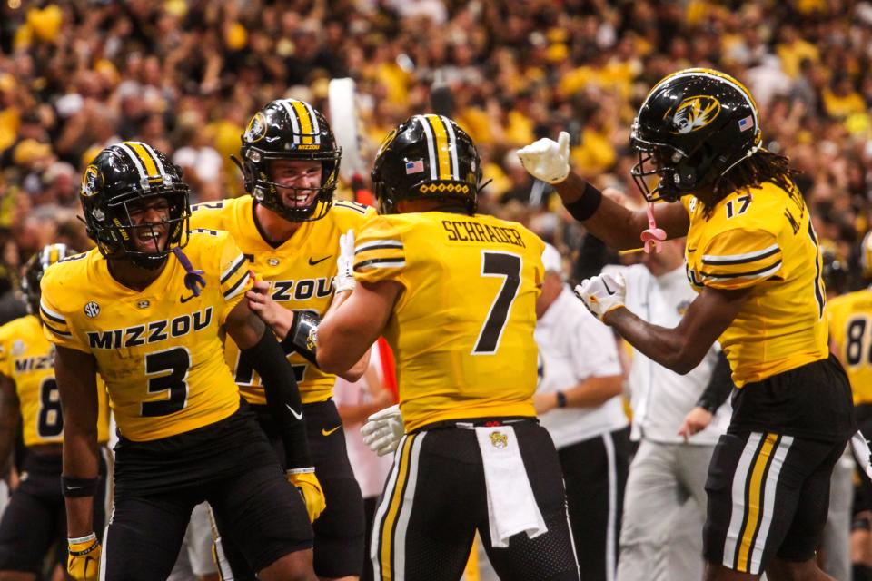 Missouri running back Cody Schrader (7) celebrates with fellow St. Louisians Luther Burden (3) and Brady Cook (12) during MU's game against Memphis at the Dome at America's Center on Sept. 23, 2023, in St. Louis, Mo.