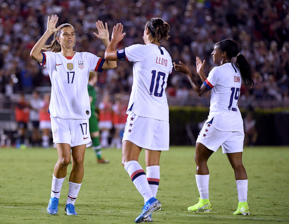 Carli Lloyd #10 of the United States celebrates her goal with Tobin Heath #17 and Crystal Dunn #19, to take a 3-0 lead over the Republic of Ireland, during the first half of the first game of the USWNT Victory Tour at Rose Bowl on August 03, 2019 in Pasadena, California. | Harry How—Getty Images