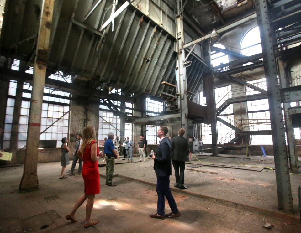 Jeff Martin, right, senior vice president of development at Industrial Commercial Properties, leads a tour of the Hoover District in North Canton.