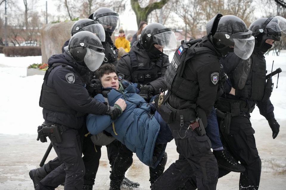 Police detain a man as he wanted to lay flowers paying their last respect to Alexei Navalny at the monument, a large boulder from the Solovetsky islands, where the first camp of the Gulag political prison system was established, in St. Petersburg, Russia on Saturday, Feb. 17, 2024. Russian authorities say that Alexei Navalny, the fiercest foe of Russian President Vladimir Putin who crusaded against official corruption and staged massive anti-Kremlin protests, died in prison. He was 47. (AP Photo)