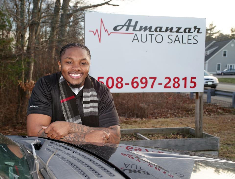 Brockton High School graduate Hakim Atkinson, co-owner of Almanzar Auto Sales, at his dealership in Bridgewater on Thursday, Dec. 29, 2022, left behind a full-time job in education to pursue his dream of becoming an entrepreneur.