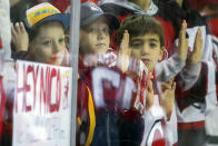 FILE - In this Oct. 14, 2019, file photo, New Jersey Devils fans watch the warm ups before the start of an NHL hockey game against the Florida Panthers, in Newark, N.J. Many NHL issues are similar to those facing North America’s other major professional leagues, such as when fans will be allowed to attend games. Others are more distinct to hockey, such as the effect the drop of the Canadian dollar will have on a league with seven of its 31 teams based north of the border. (AP Photo/Mary Altaffer, File)