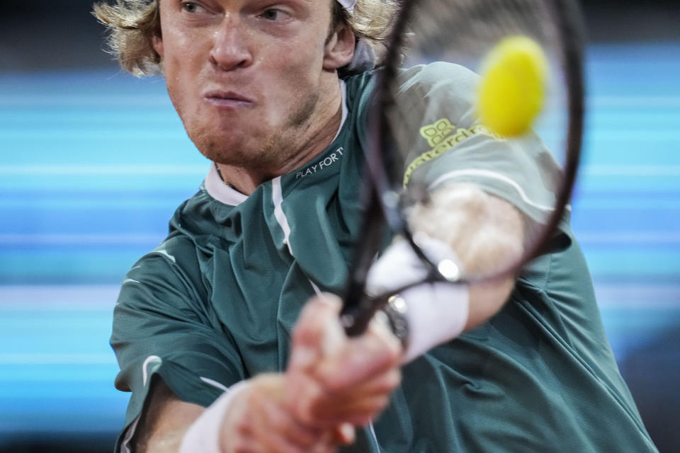 Andrey Rublev, of Russia, returns the ball to Carlos Alcaraz, of Spain, during the Mutua Madrid Open tennis tournament in Madrid, Wednesday, May 1, 2024. (AP Photo/Manu Fernandez)