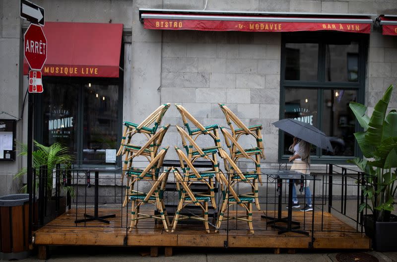 FILE PHOTO: Chairs are stacked outside a bistro in Montreal