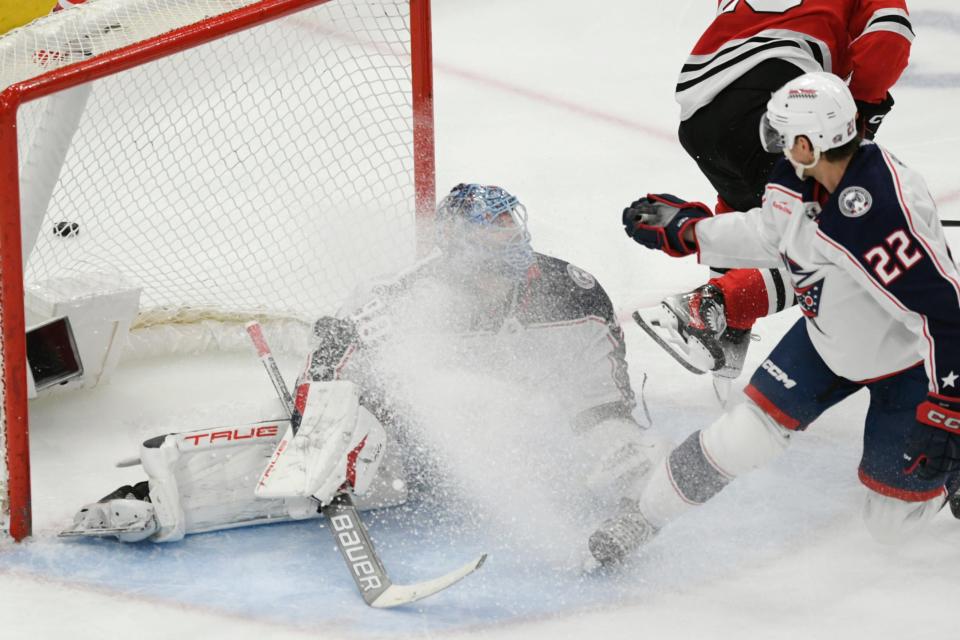 Columbus Blue Jackets goalie Elvis Merzlikins (90) defends the goal while getting sprayed with ice by Blackhawks' Nikita Zaitsev during the third period of an NHL hockey game against the Chicago Blackhawks, Saturday, March 2, 2024, in Chicago. (AP Photo/Paul Beaty)