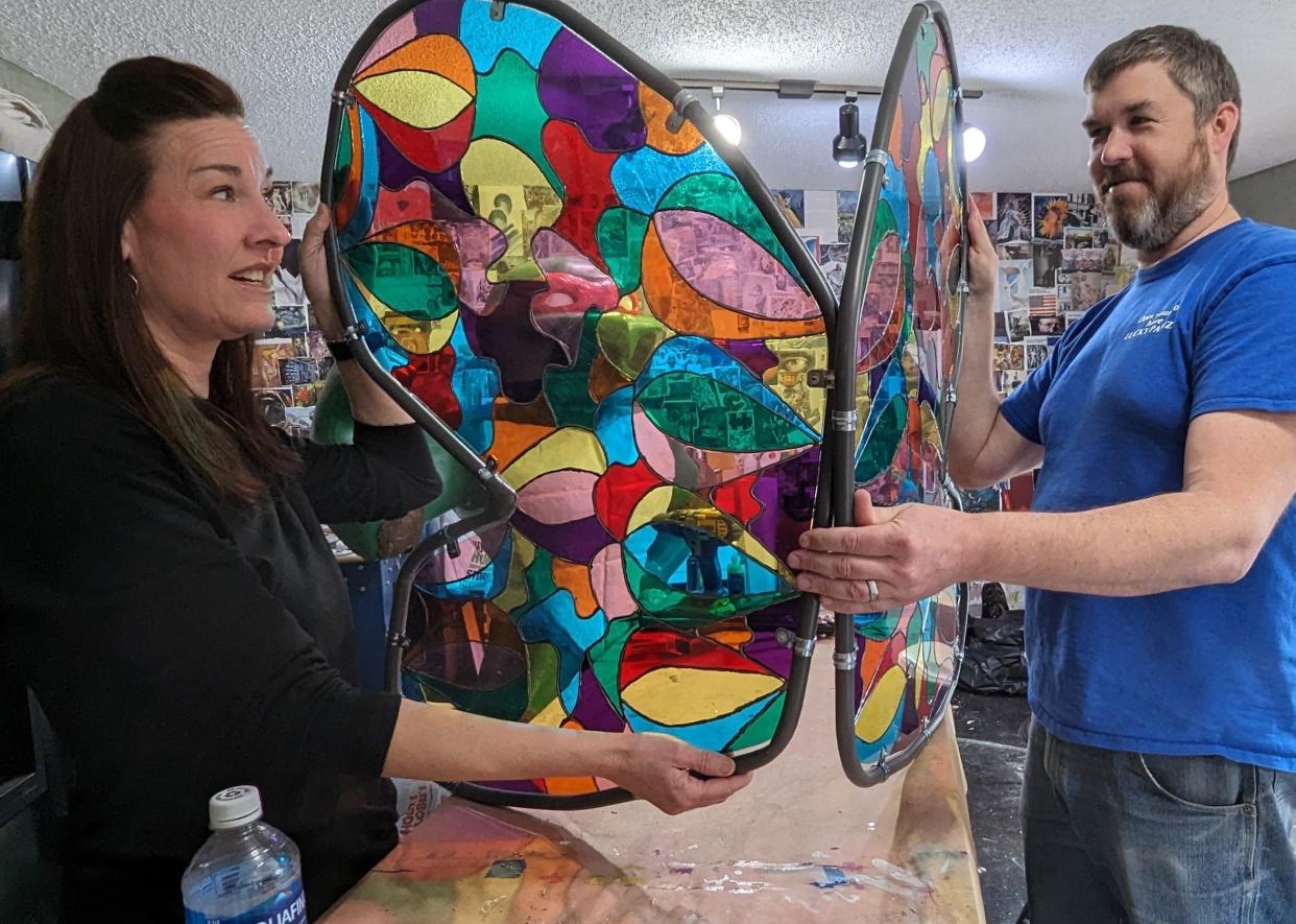 April and Jim Kelly discuss the creative faux stained glass wings they will apply to the Tooth Fairy version of Herky they are preparing for the current Herky on Parade event this spring. Both hold art degrees and are veteran artists from past Herky projects.