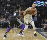 Sacramento Kings guard Yogi Ferrell, left, fouls Golden State Warriors guard Stephen Curry, right, during the first half of an NBA basketball game Friday, Dec. 14, 2018, in Sacramento, Calif. (AP Photo/Rich Pedroncelli)