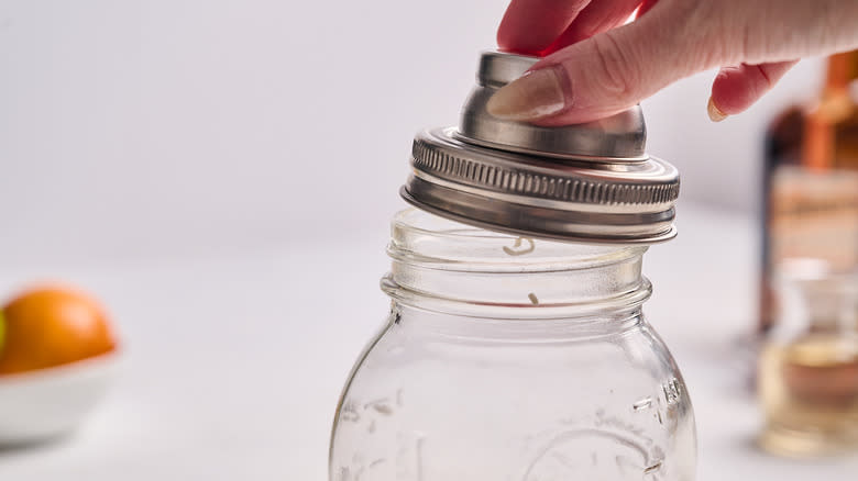 putting lid on cocktail shaker