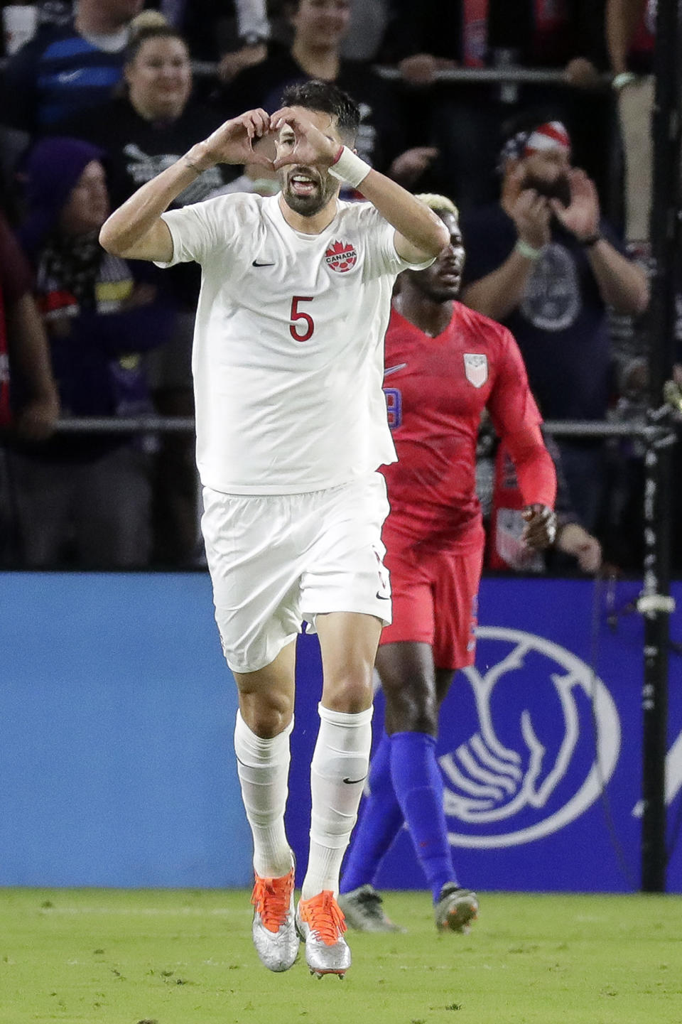 Canada defender Steven Vitoria (5) makes a heart shape with his hands after scoring a goal against the United States during the second half of a CONCACAF Nations League soccer match Friday, Nov. 15, 2019, in Orlando, Fla. (AP Photo/John Raoux)