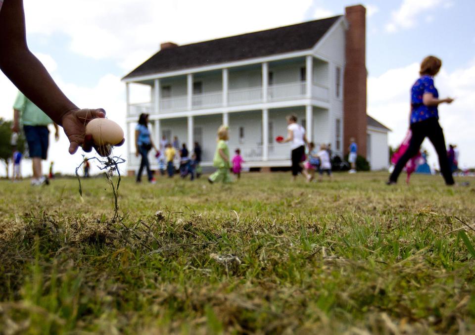 Children search for eggs in an old-fashioned Easter egg hunt outside the 1860's Ryon Prairie Home at the George Ranch Historical Park, Saturday, April 19, 2014, in Houston. Children were able to step back in time and play games popular in the 1800's and decorate eggs. (AP Photo/Houston Chronicle, Johnny Hanson)