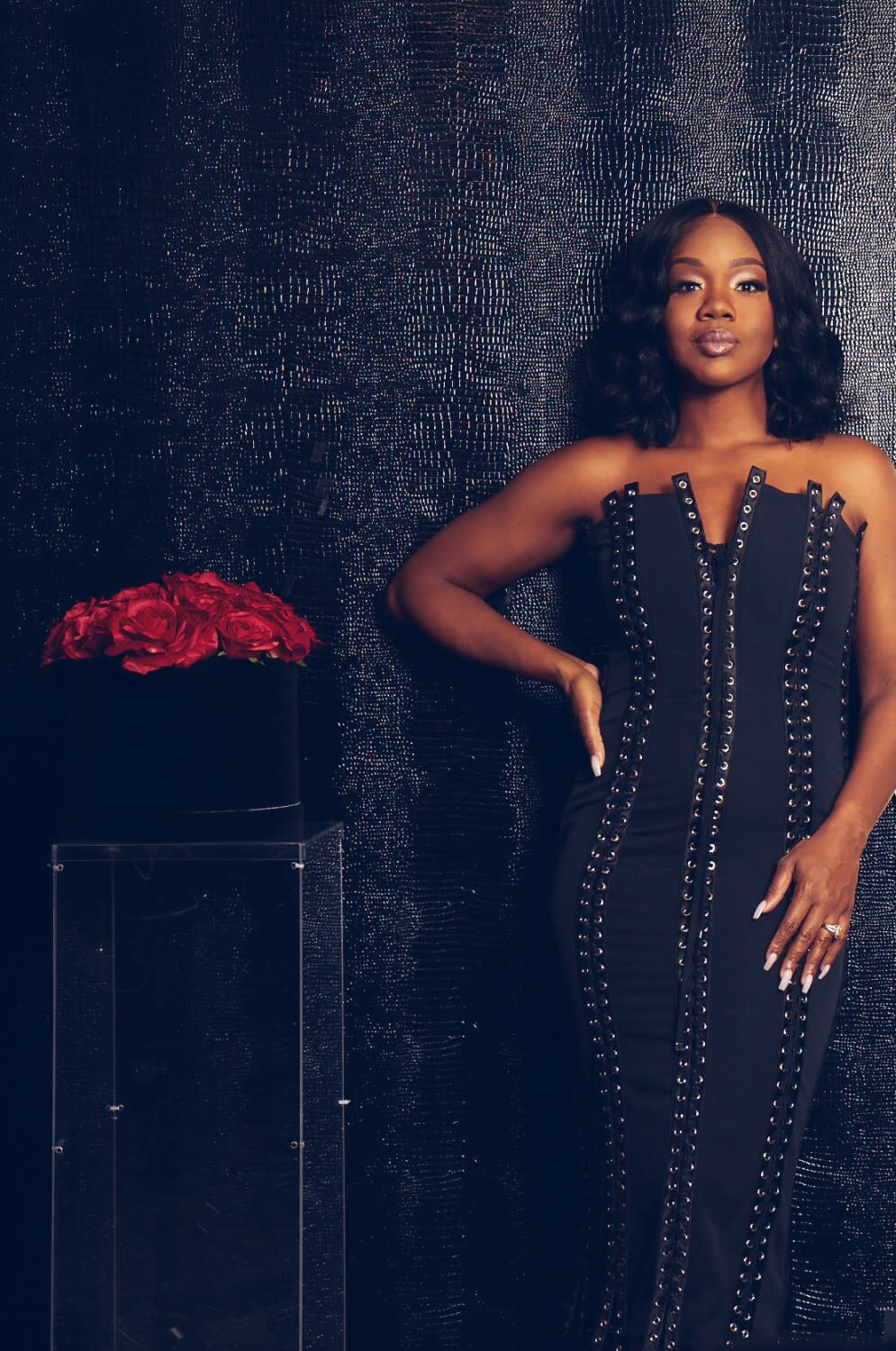 Photo of Sarah Jakes Roberts standing in a black dress.