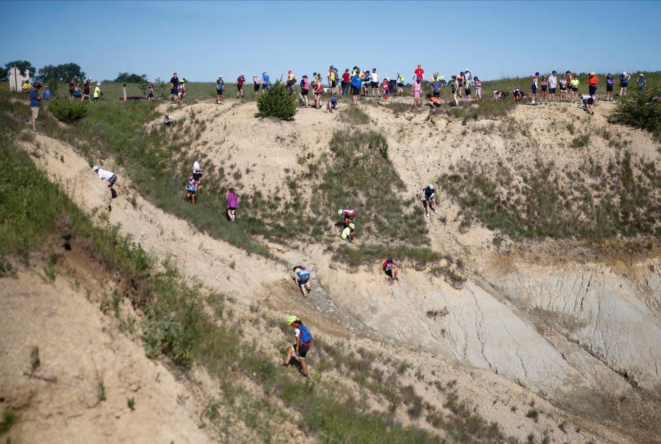 Cyclists explore the Floyd County Fossil & Prairie Center outside Rockford during RAGBRAI on Thursday.