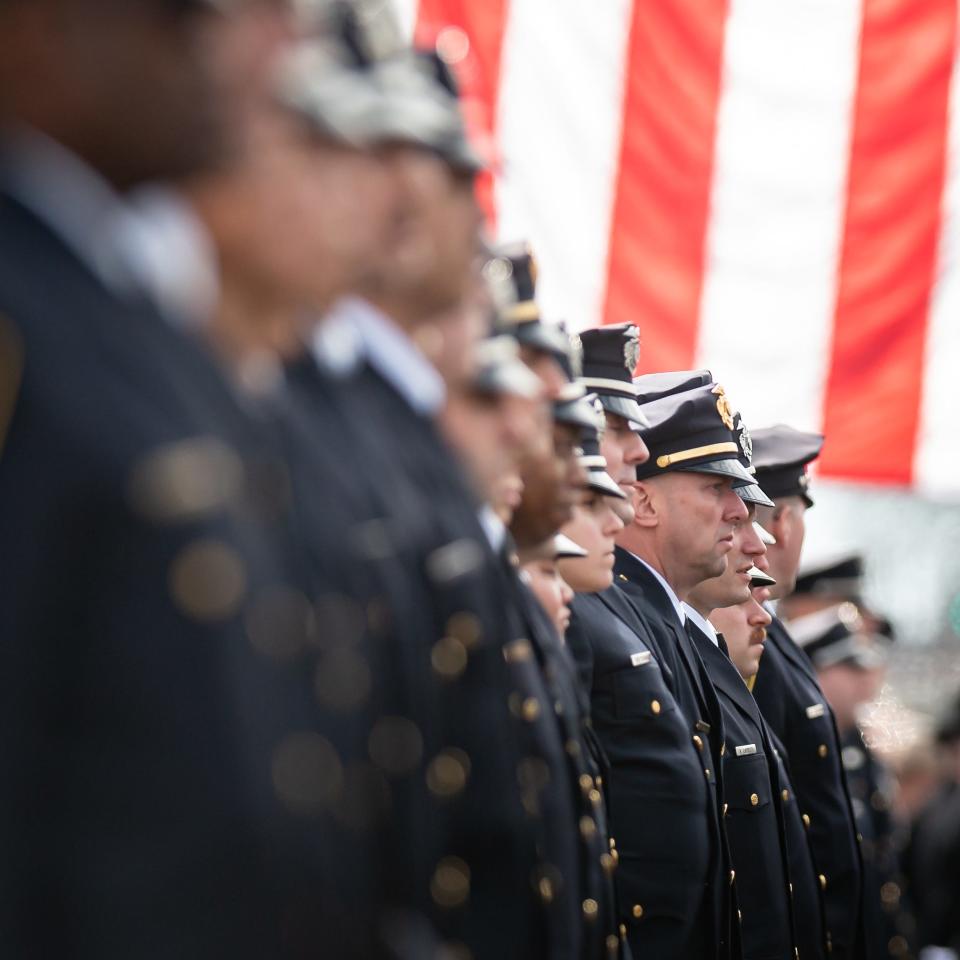 Syracuse police officers stand in formation at St. John the Baptist church in Rome, NY on Saturday, April 20, 2024.