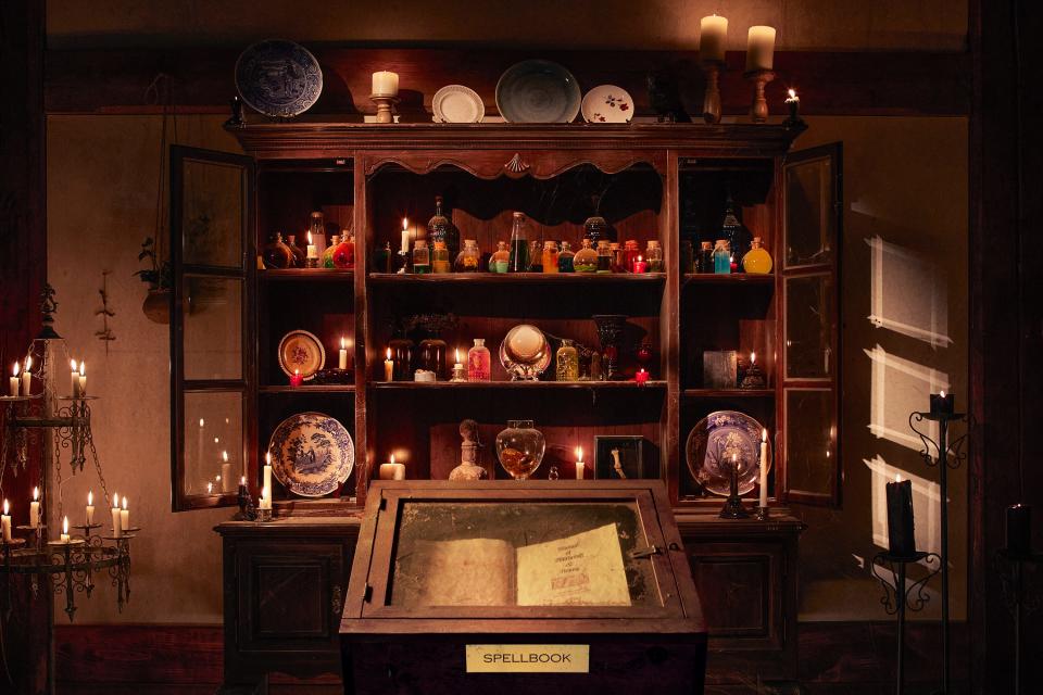 The Sanderson sister's spell book is seen nearby shelves of "potions."