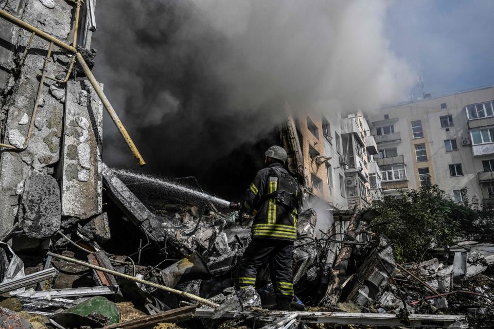 A firefighter extinguishes a fire after a flat was hit by a missile strike in Bakhmut, Donetsk region, on September 15, 2022, amid the Russian invasion of Ukraine. - Thick white smoke, visible for miles around, rises over Bakhmut: this Ukrainian-controlled town in the Donbas is still under Russian offensive pressure despite the retreat of Moscow's troops in the northeast. (Photo by Juan BARRETO / AFP) (Photo by JUAN BARRETO/AFP via Getty Images)