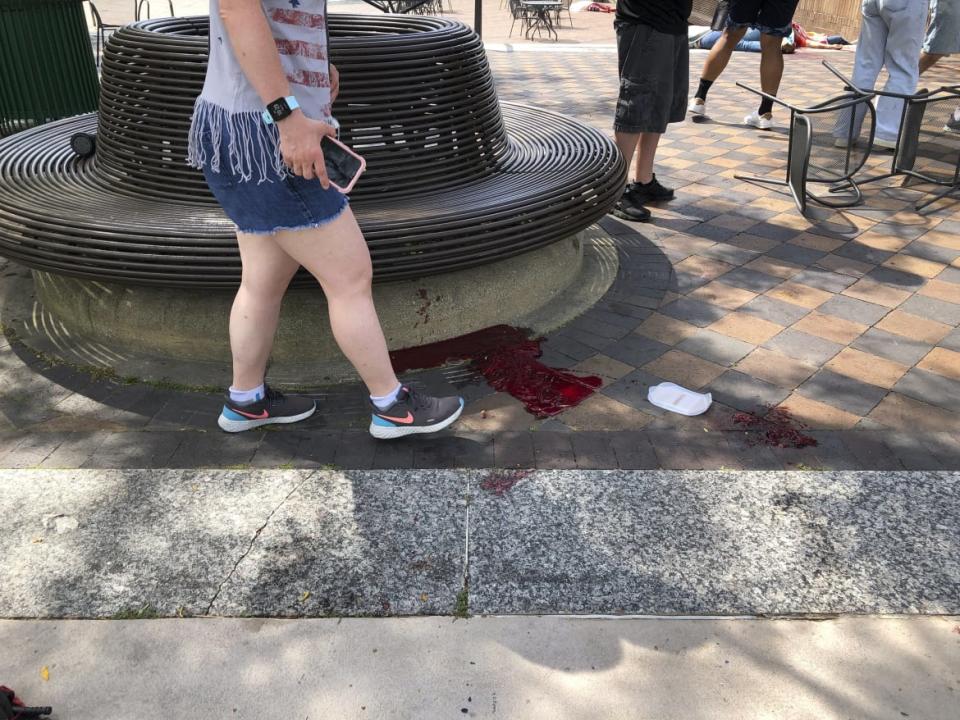 <div class="inline-image__caption"><p>Blood pooled at Port Clinton Square in Highland Park, after a shooting at a Fourth of July parade.</p></div> <div class="inline-image__credit">Lynn Sweet/Chicago Sun-Times via AP</div>