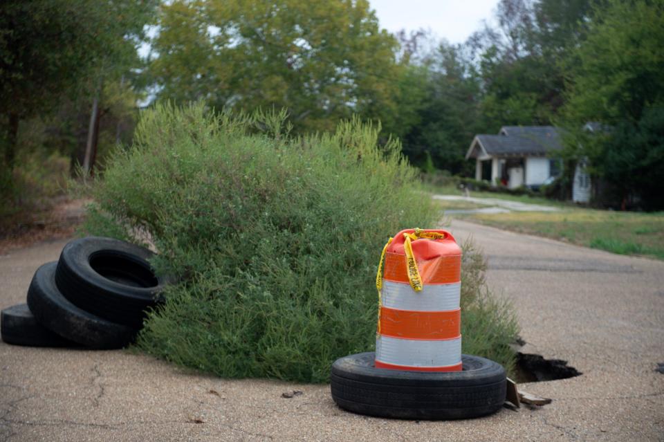 A pothole at the intersection of Denver and Long Streets in Jackson appears to be wider than the ragweed growing out of it is tall on Oct. 26.