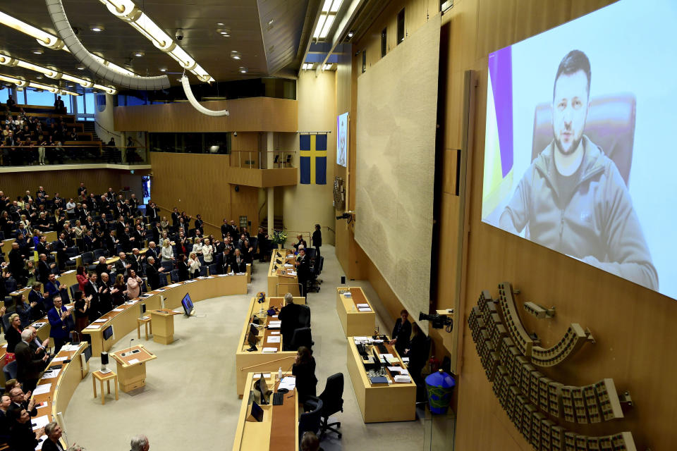 FILE - Ukraine's President Volodymyr Zelenskyy receives a standing ovation as he addresses Sweden's parliament via video link, in Stockholm, March 24, 2022. Security concerns over Russia’s ongoing invasion of Ukraine changed the calculus for Finland and Sweden which have long espoused neutrality and caused other traditionally “neutral” countries to re-think what that term really means for them. (Paul Wennerholm/TT News Agency via AP, File)