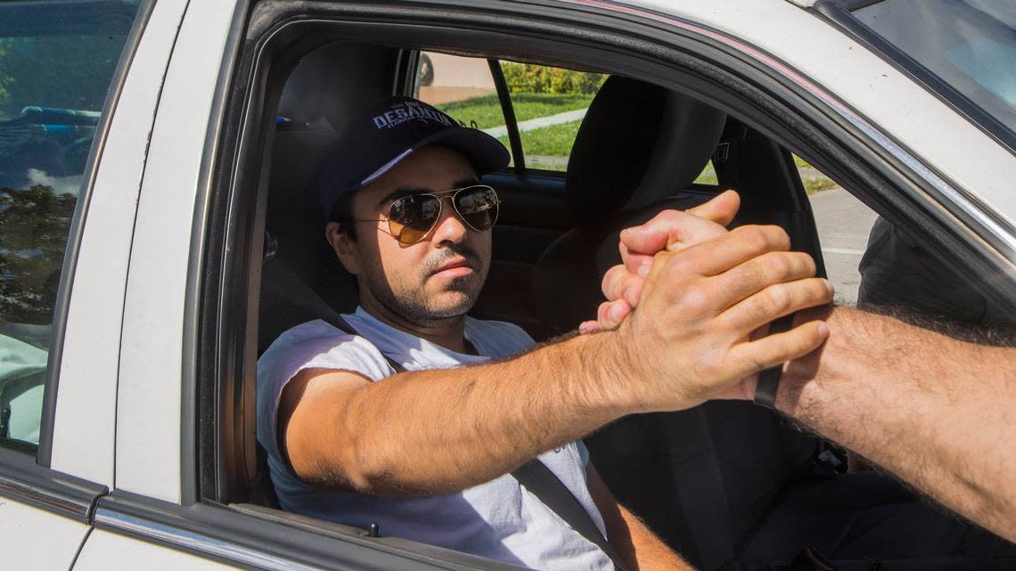 Christopher Monzon, the Republican Party canvasser attacked in Hialeah while handing out fliers for Sen. Marco Rubio, greets supporters during a Proud Boys rally in Hialeah as he appeared in public for the first time after getting out of the hospital.
