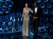 FILE PHOTO: Actors Jolie and Poitier take the stage to present the Oscar for achievement in directing at the 86th Academy Awards in Hollywood