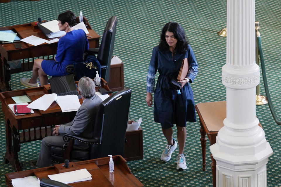 Texas State Sen. Carol Alvarado, D-Houston, wears running shoes as she prepares to filibuster Senate Bill 1, a voting bill, at the Texas Capitol Wednesday, Aug. 11, 2021, in Austin, Texas. (AP Photo/Eric Gay)