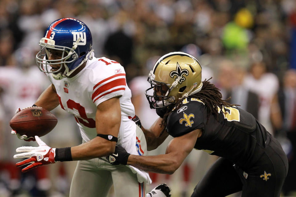 NEW ORLEANS, LA - NOVEMBER 28: Wide receiver Ramses Barden #13 of the New York Giants runs after a catch for a 26-yard gain as he is tackled by cornerback Patrick Robinson #21 of the New Orleans Saints in the first quarter at Mercedes-Benz Superdome on November 28, 2011 in New Orleans, Louisiana. (Photo by Ronald Martinez/Getty Images)