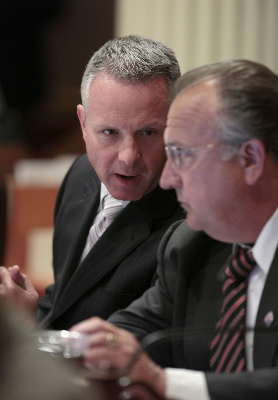 State Sen. Anthony Canella, R-Ceres, left, talks with Sen. Bob Dutton, R-Rancho Cucamonga, as lawmakers debate one of the budget-related bills at the Capitol in Sacramento, Calif. Wednesday, June 27, 2012. Lawmakers approved 21 budget implementing bills to deal with a $15.7 billion budget deficit. (AP Photo/Rich Pedroncelli)