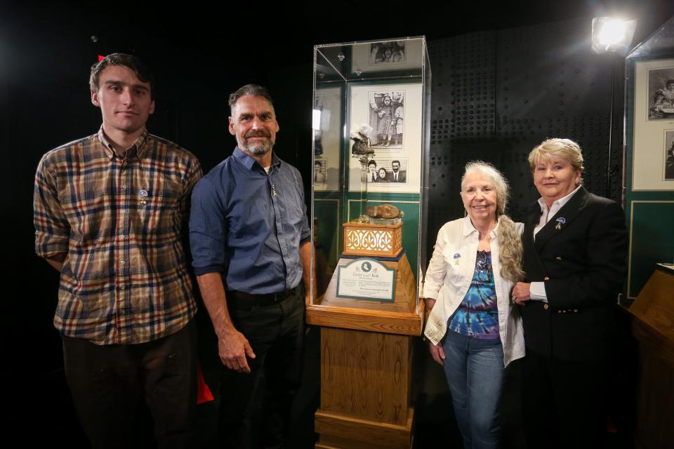 From left to right, Gabriel Studer-Randall, Paul Randall, Joan Randall and Mary Kellogg-Joslyn pose for a portrait next to the temporary display of Louise "Luise" Kink's shoes at the Titanic Museum Attraction in Branson on Tuesday, June 6, 2023. Kink was one of 135 children aboard the Titanic on the evening it sank on April 15, 1912. Joan is one of only a handful of direct descendants of Titanic survivors.