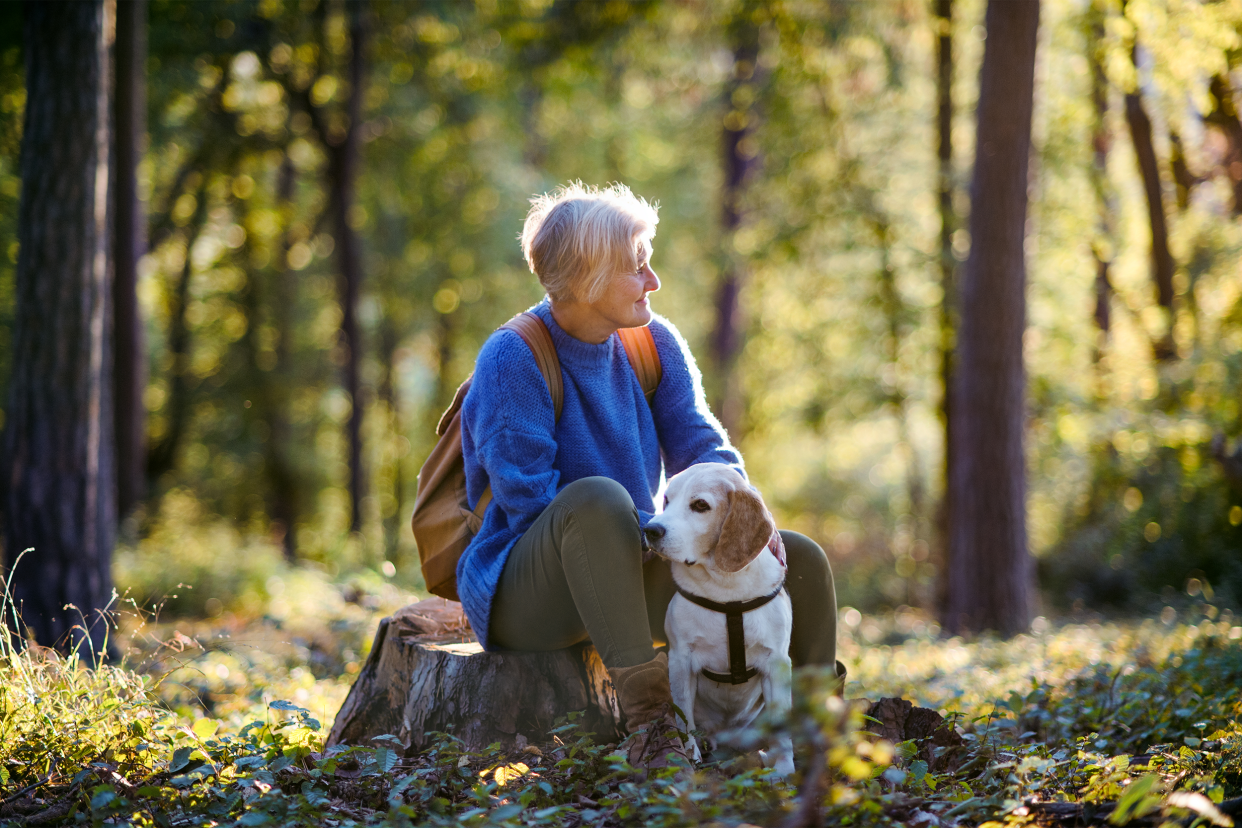 senior woman outside with dog