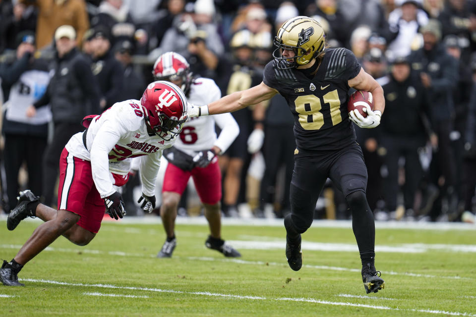 Purdue tight end George Burhenn (81) holds off Indiana defensive back Louis Moore (20) on his way to a touchdown during the first half of an NCAA college football game in West Lafayette, Ind., Saturday, Nov. 25, 2023. (AP Photo/Michael Conroy)
