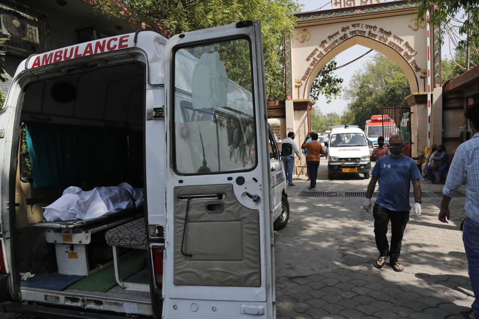 A body of a person who died of COVID- 19 lies in an ambulance for cremation in New Delhi, India, Monday, April 19, 2021. India's health system is collapsing under the worst surge in coronavirus infections that it has seen so far. Medical oxygen is scarce. Intensive care units are full. Nearly all ventilators are in use, and the dead are piling up at crematoriums and graveyards. Such tragedies are familiar from surges in other parts of the world — but were largely unknown in India. (AP Photo/Manish Swarup)