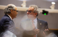 Luxembourg's Finance Minister Pierre Gramegna, right, speaks with Malta's Finance Minister Edward Scicluna during a meeting of EU finance ministers at the Europa building in Brussels, Tuesday, Feb. 18, 2020. EU finance ministers meet Tuesday to discuss tax havens. (AP Photo/Virginia Mayo)