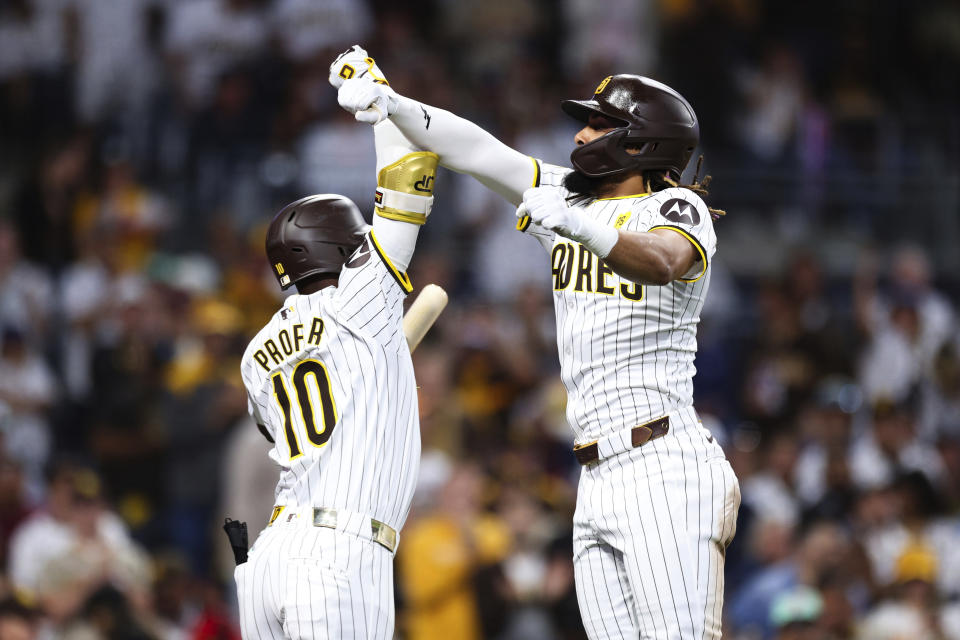 San Diego Padres' Fernando Tatis Jr., right celebrates with Jurickson Profar after hitting a solo home run against the Milwaukee Brewers during the fifth inning of a baseball game Thursday, June 20, 2024, in San Diego. (AP Photo/Derrick Tuskan)