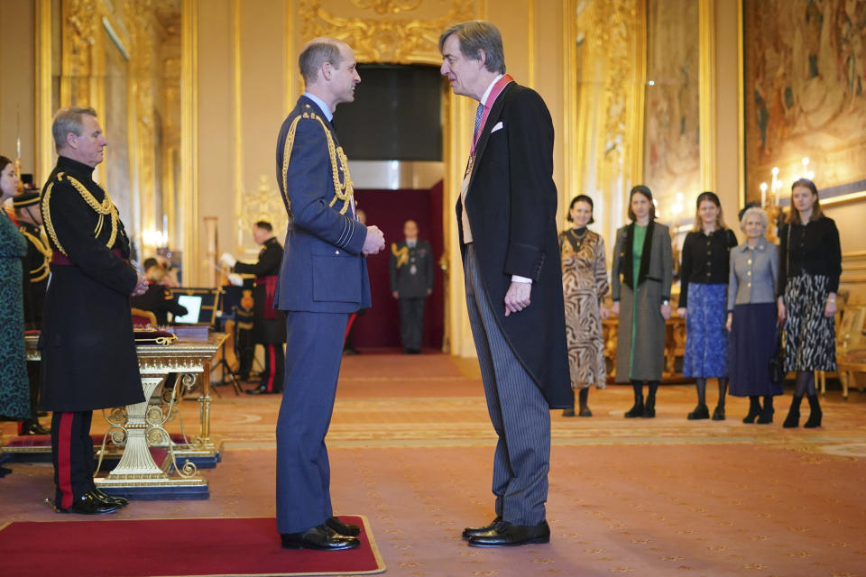 Britain's Prince William, the Prince of Wales, centre left, awards Edward Harley, Chair of the Acceptance in Lieu (AIL) Panel, with the Commander of the Order of the British Empire, at Windsor Castle, Windsor, England, Wednesday, Feb. 7, 2024. The honour recognises services to heritage, to charity and to the community in Herefordshire. (Yui Mok/PA via AP)