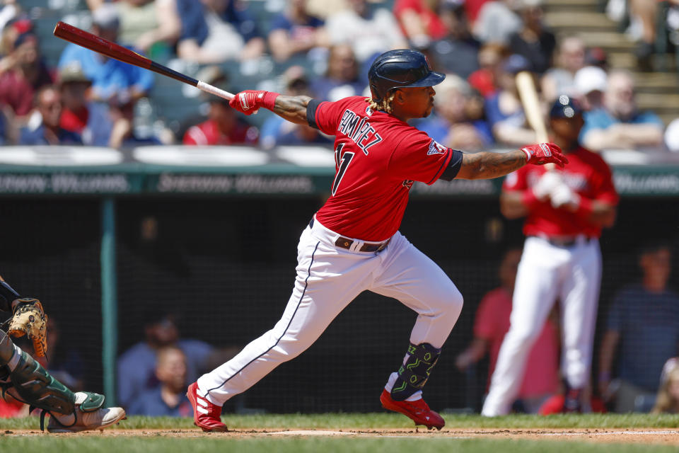 Cleveland Guardians' José Ramírez hits a two-run double against the Oakland Athletics during the first inning of a baseball game, Sunday, June 12, 2022, in Cleveland. (AP Photo/Ron Schwane)