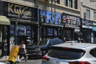 FILE - This Aug. 28, 2019, file photo shows a bustling street lined with wholesale vape shops in downtown Los Angeles. A shadowy but widely sold illegal marijuana vape is drawing the attention of investigators looking into a rash of mysterious lung illnesses around the U.S. So far, investigators have not identified a culprit in the illnesses reported in dozens of states. But officials say patients have mentioned Dank - a slang word for highly potent cannabis- name frequently. (AP Photo/Richard Vogel, File)