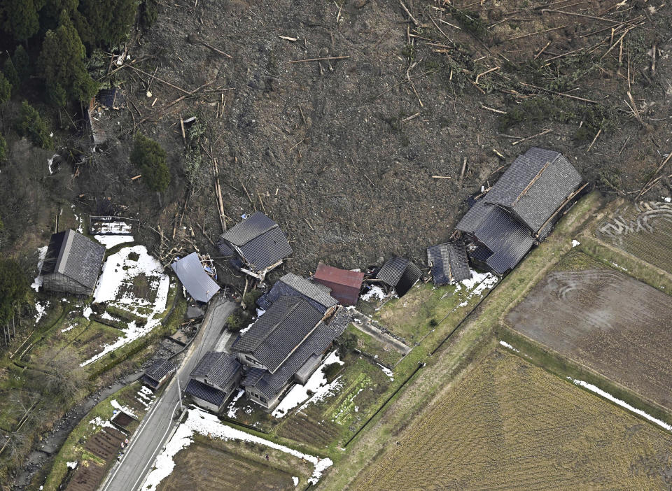 This aerial photo shows houses are collapsed by landslides caused by earthquakes in Wajima, Ishikawa prefecture, Japan Thursday, Jan. 4, 2024. More soldiers have been ordered to bolster the rescue operations Thursday, providing those in need with drinking water, hot meals and setting up bathing facilities after a magnitude 7.6 quake hit Ishikawa Prefecture and nearby regions Monday. (Kyodo News via AP)